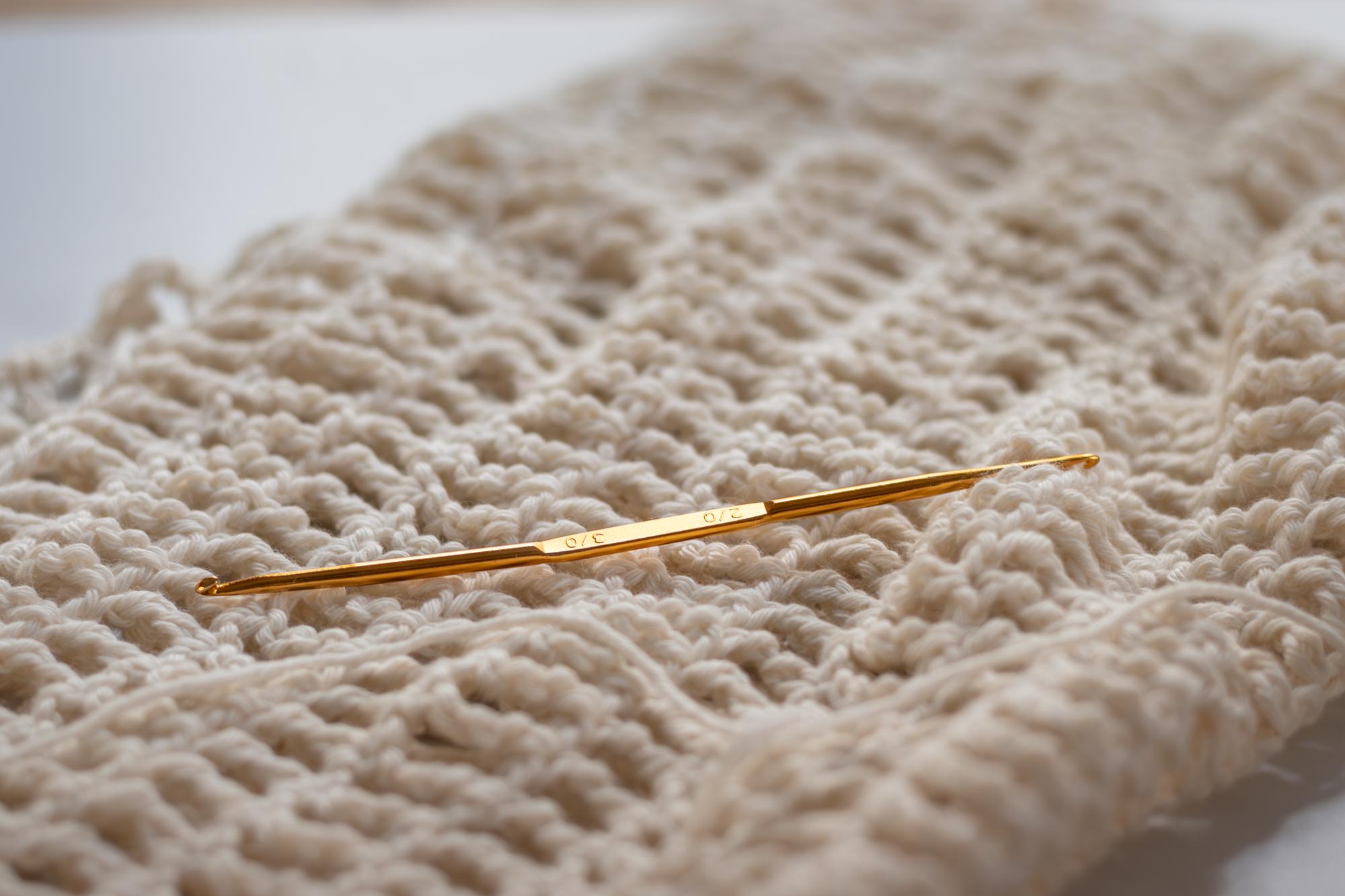 Close-up of gold-thread hand embroidery on silk